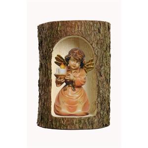 Bell angel with candle-carrier in a tree trunk